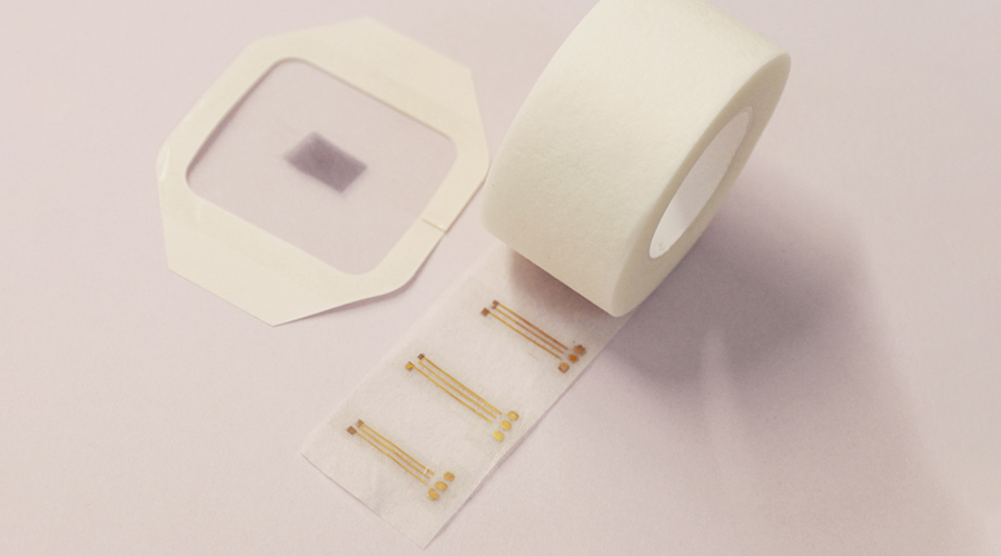 Closeup shot of a roll of the semiconductors on a pink background