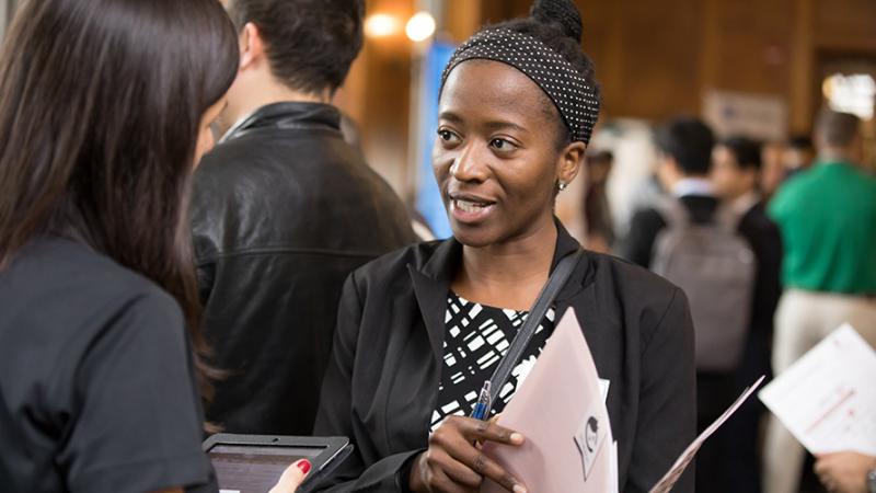 Two people talking at a career fair