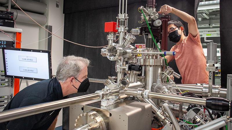 Michael Rodgers and Chenhui Yan work together on lab equipment