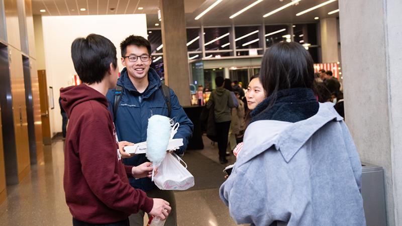 Students congregate and eat carnival food