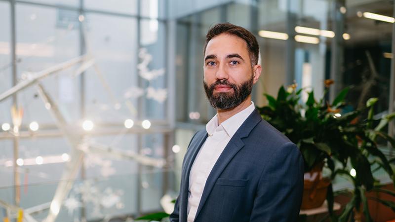 Man with beard and suit in open atrium