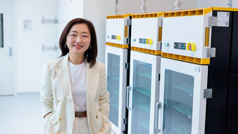 Shirley Meng in front of battery storage containers