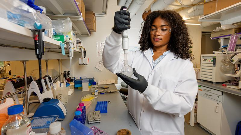 Madison Chisolm using a pipette in the lab