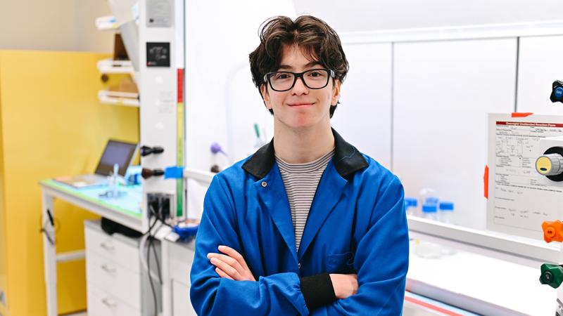 High school student in blue lab coat