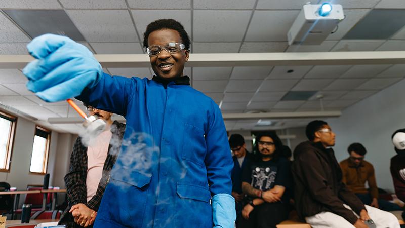 Student holds vial