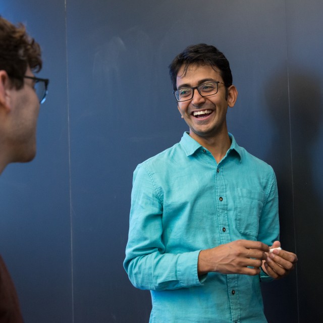 Two PME students share a moment during a class break