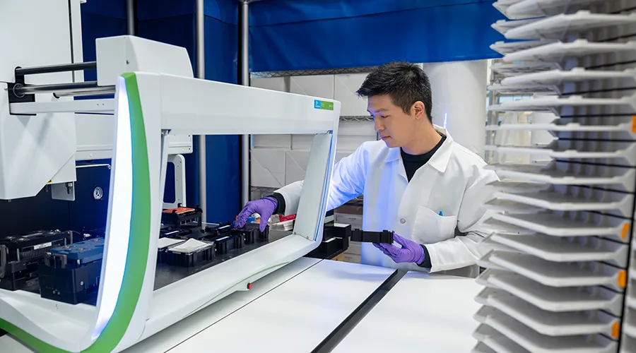Graduate student Yifeng (Oliver) Tang in the automated robotic screening center