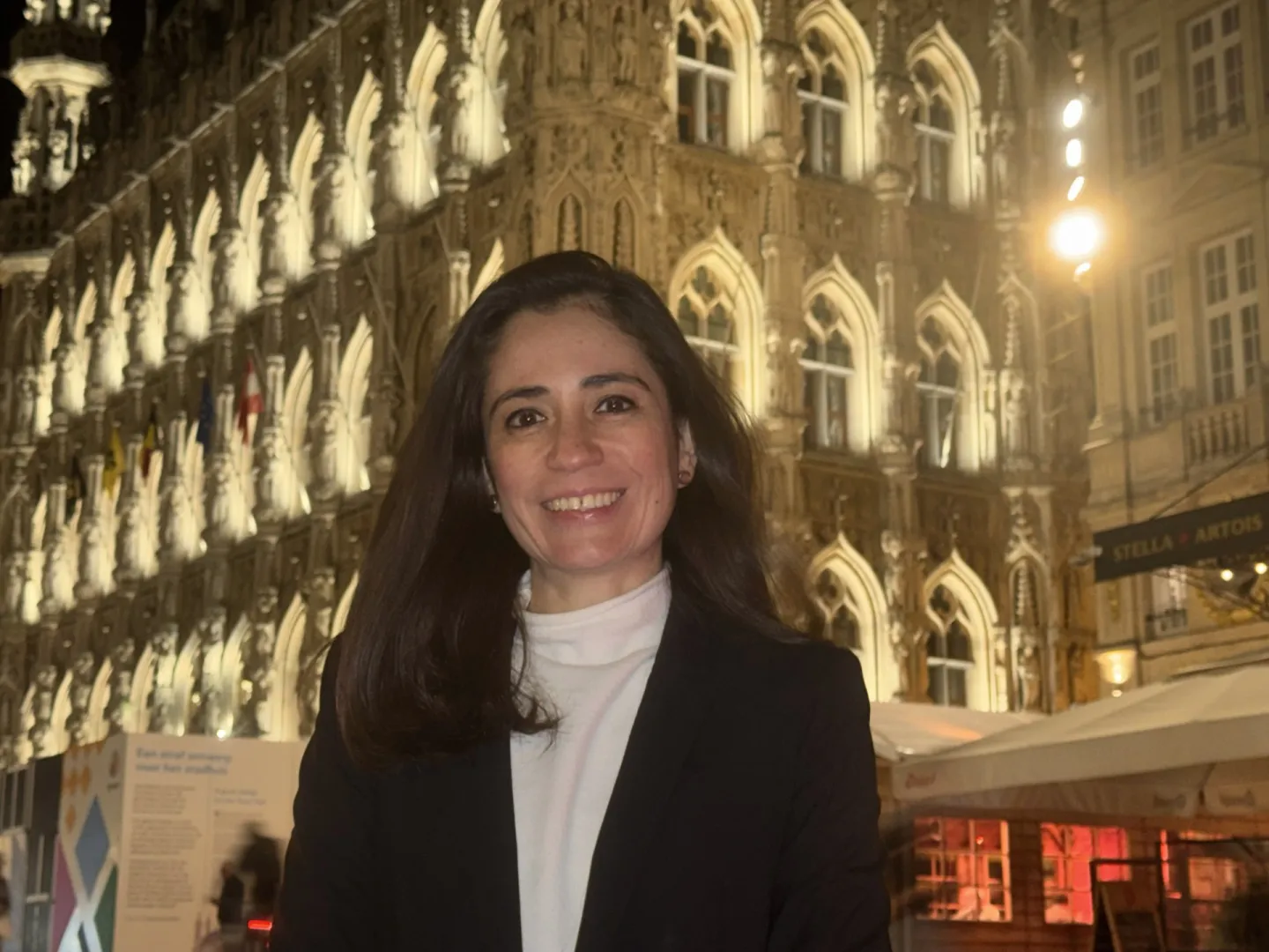 Woman standing in front of Leuven City Hall in Belgium