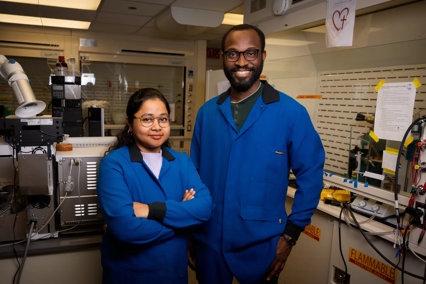 Two scientists pose in a lab setting