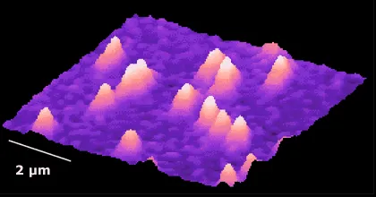 Atomic force microscopy image of a gallium nitride (GaN) surface showing nanoscale island-like features and roughness across a 2 micrometer area. Bright peaks indicate elevated surface structures formed during GaN material growth.