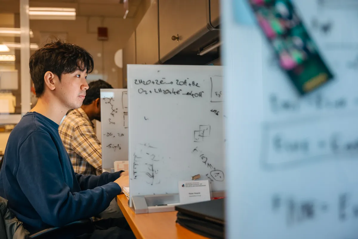 Man sitting at a computer typing