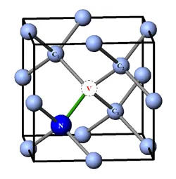 Atomic model of a nitrogen-vacancy–like defect used in quantum computing research. The diagram shows a vacancy adjacent to a nitrogen atom within a crystal lattice, illustrating localized electronic states that enable spin-based quantum information processing and sensing applications.