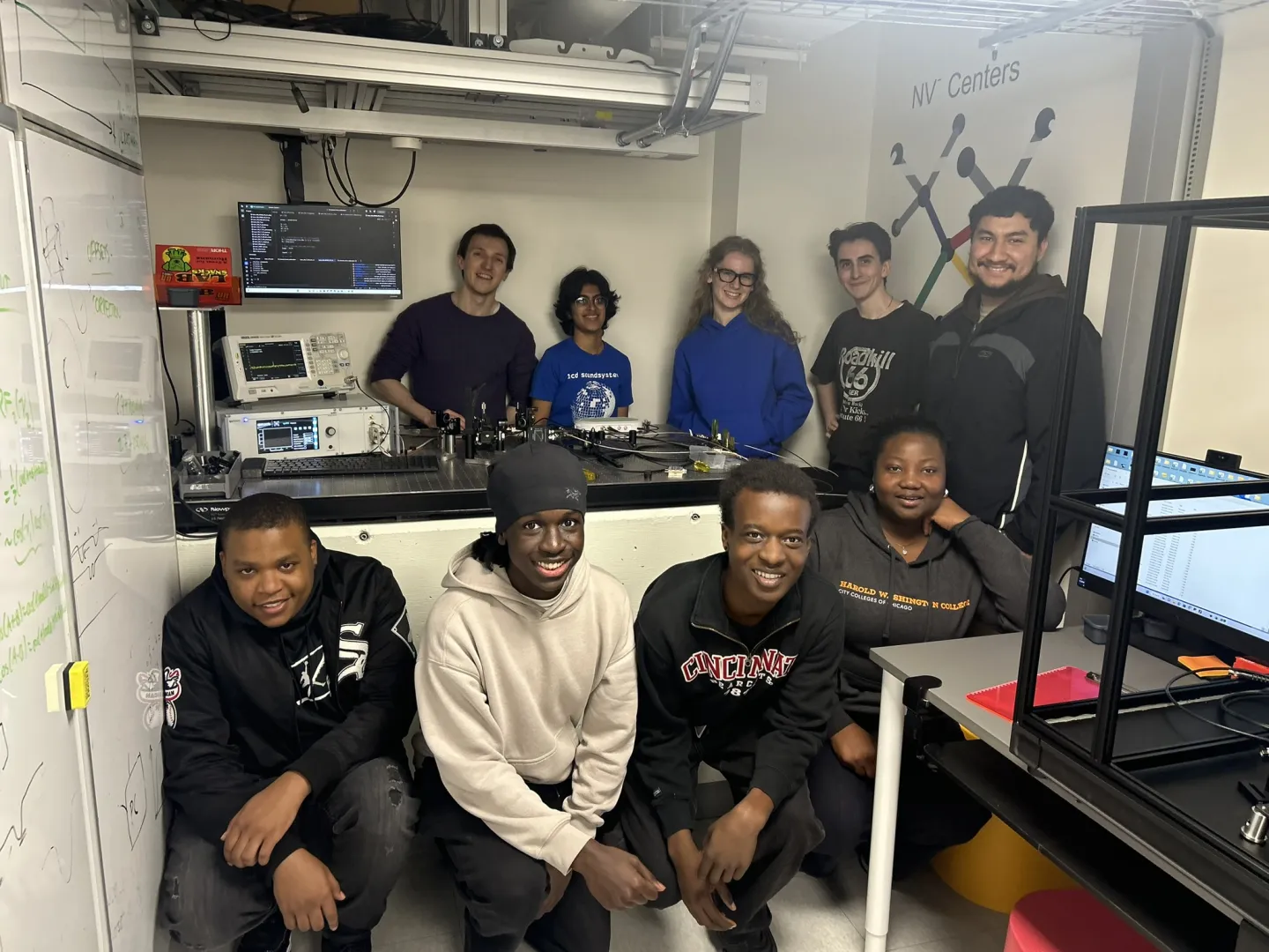Students in quantum laboratory posing for picture