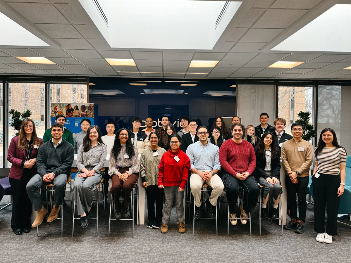 Large group of students and staff pose for photo