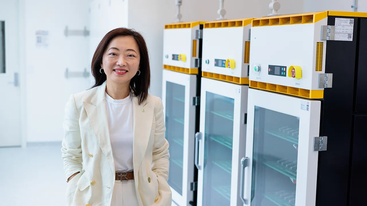 Shirley Meng in front of battery storage containers