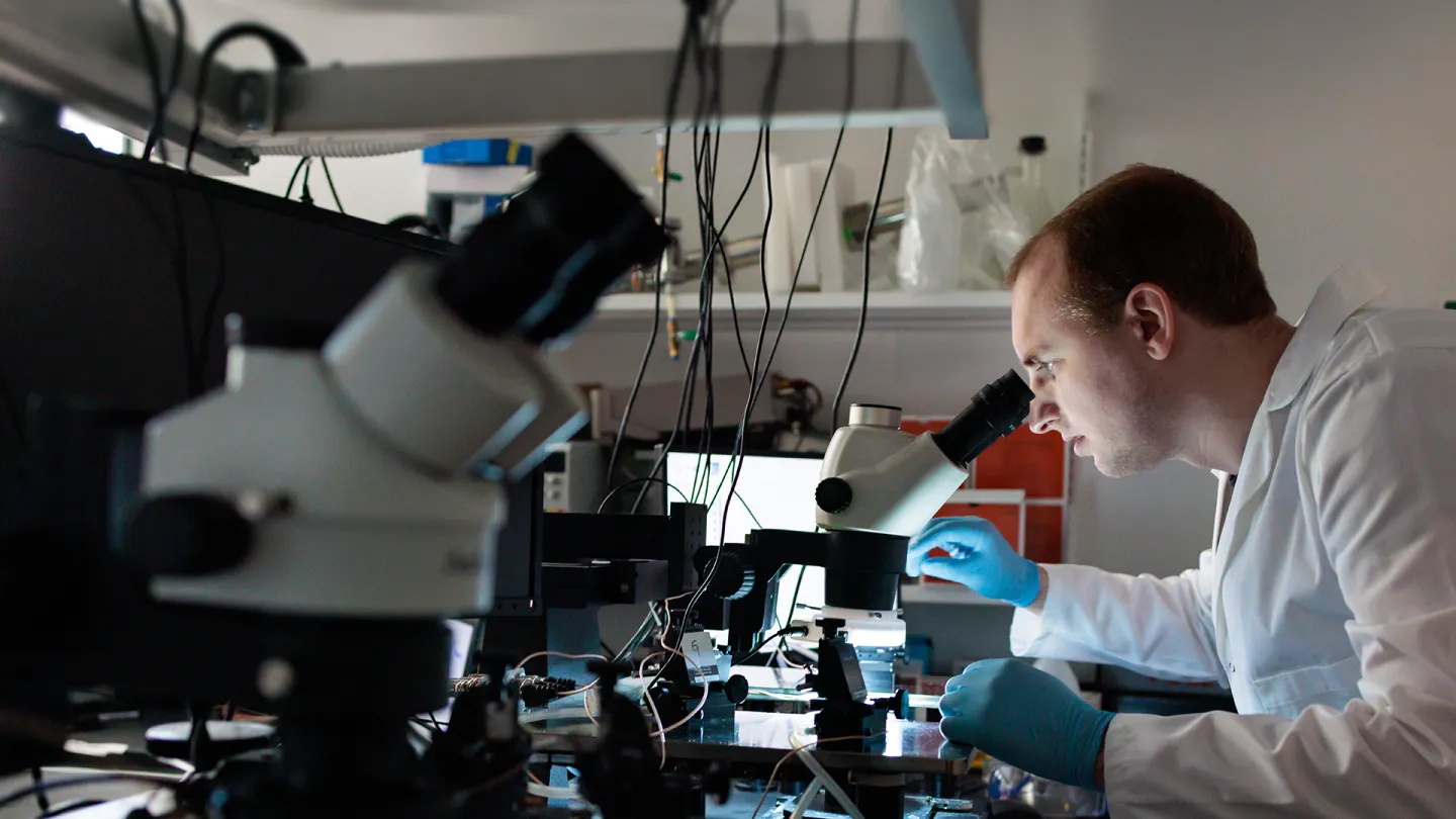 Researcher with microscope