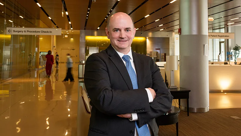Man standing in hospital lobby