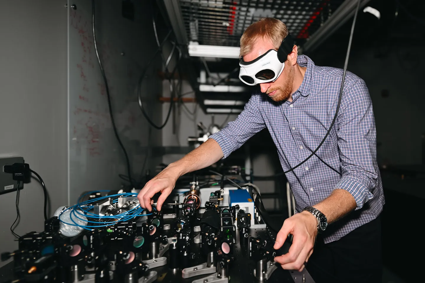 Man in goggles working on scientific equipment