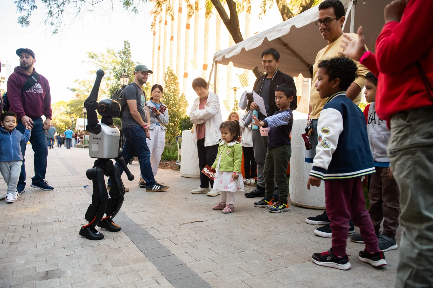 Children look at small dancing robot at the University of Chicago South Side Science Festival