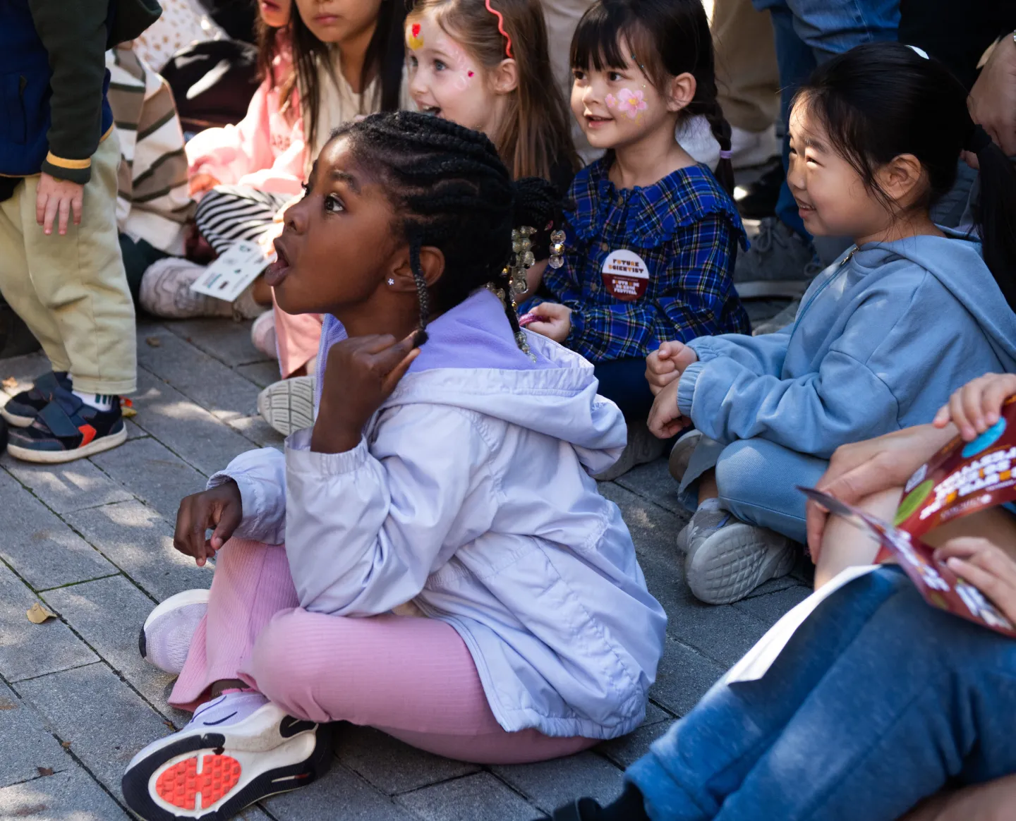 Young girl excitedly watching science demonstration at the University of Chicago South Side Science Festival